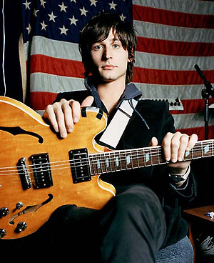 Nick of the The Strokes holding a guitar. Rock / indie band in NYC 10/2004 NME.