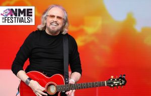 Watch Barry Gibb play the Bee Gees' 'Tragedy' in a gold jacket given to him by the Glastonbury crowd