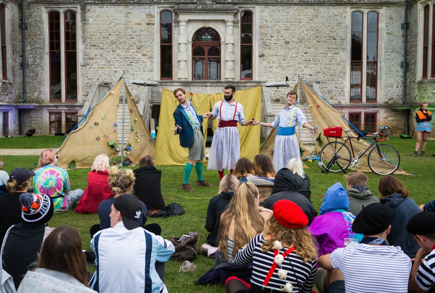 Revellers enjoy a play in front of The Castle.