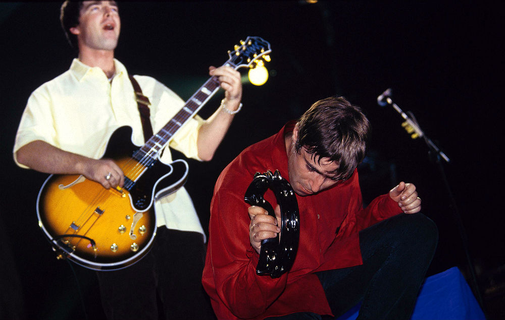 Noel and Liam Gallagher live with Oasis in 1997