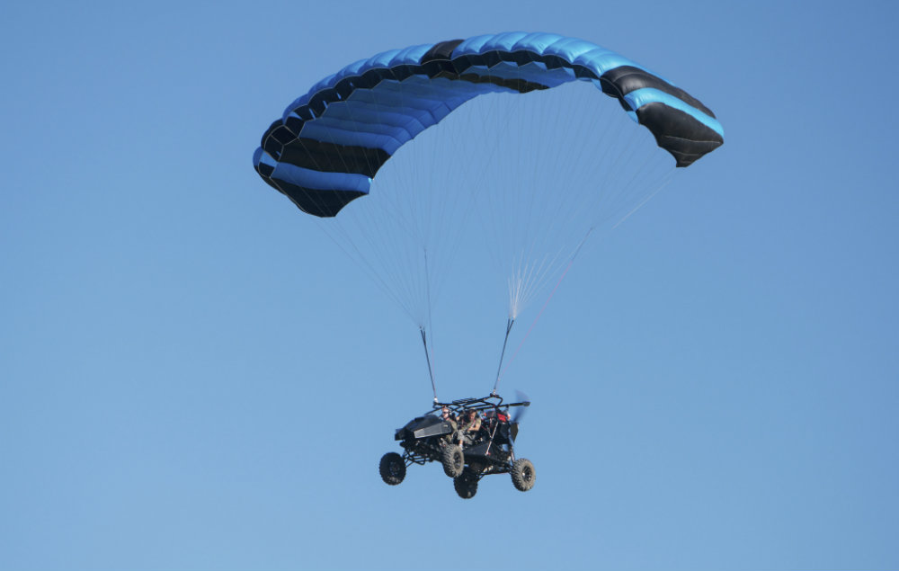 A car attached to a paraglider in the trailer for Top Gear