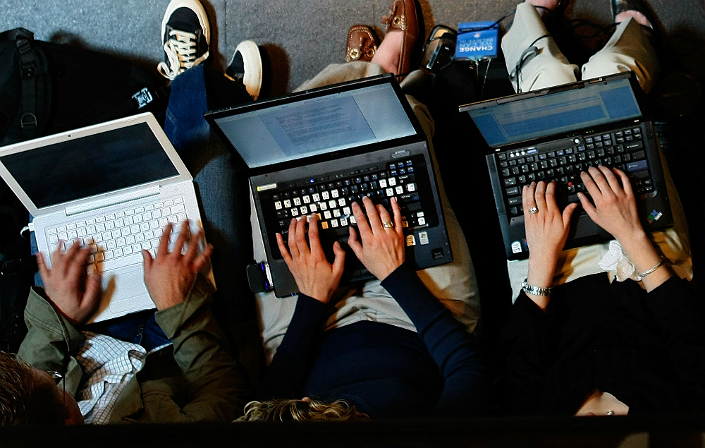 Three people browsing the web on laptops