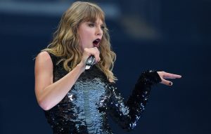 Taylor Swift 'third wheels' as two fans get engaged during meet-and-greet
