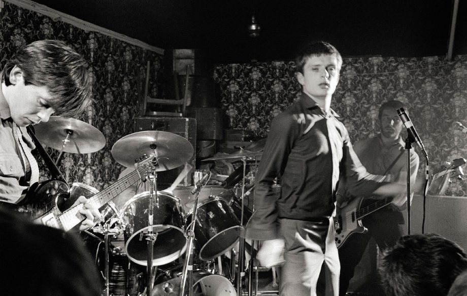 L-R: Bernard Sumner, Ian Curtis, Peter Hook performing live onstage at Bowdon Vale Youth Club