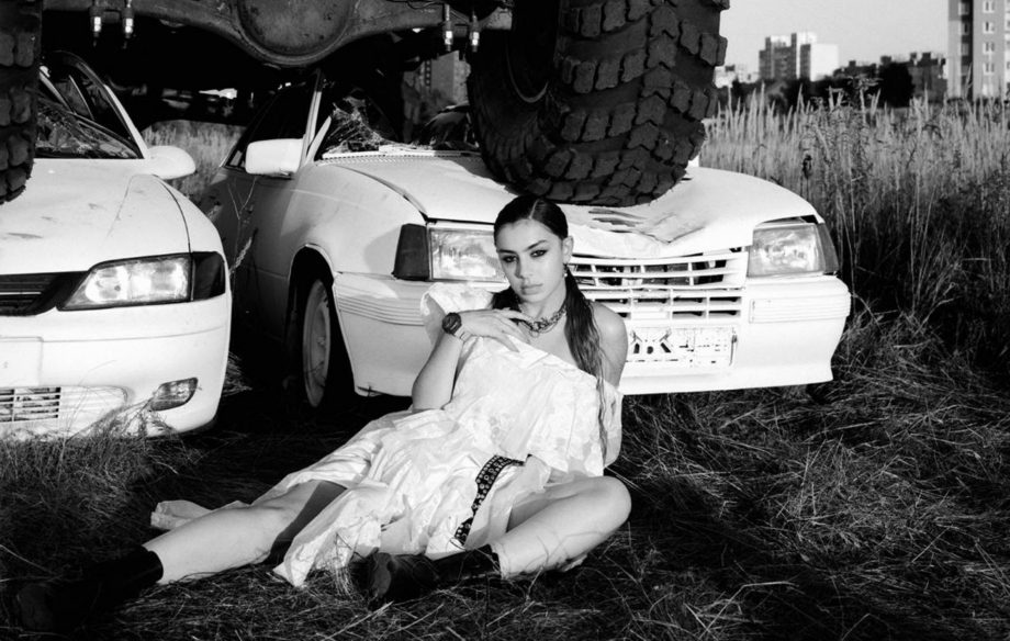 Watch Charli XCX sing from a suspended car in 'White Mercedes' video
